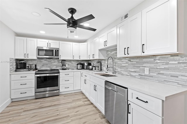 802 Cypress Grove Ln Unit 409, Pompano Beach, FL 33069 - kitchen with appliances with stainless steel finishes, a sink, ceiling fan, white cabinets, and recessed lighting