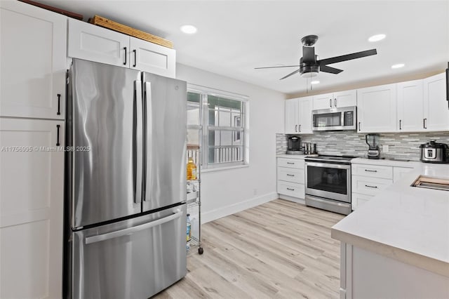 802 Cypress Grove Ln Unit 409, Pompano Beach, FL 33069 - kitchen featuring appliances with stainless steel finishes, a ceiling fan, light countertops, baseboards, and tasteful backsplash