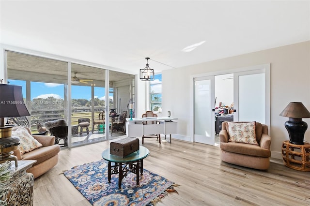 802 Cypress Grove Ln Unit 409, Pompano Beach, FL 33069 - living room with an office area, light wood finished floors, floor to ceiling windows, and a ceiling fan