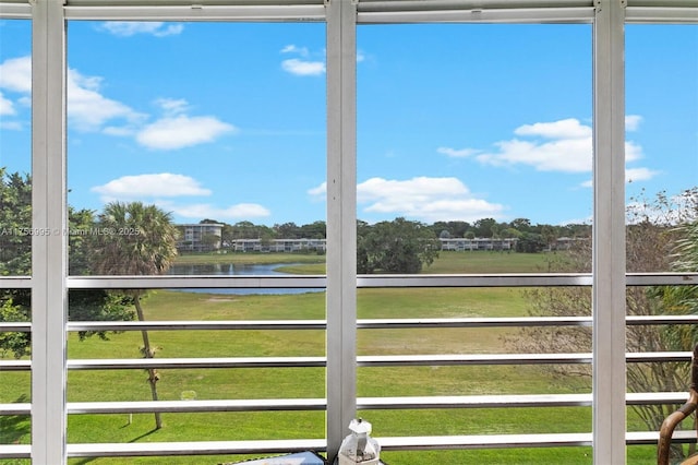 unfurnished sunroom featuring a water view