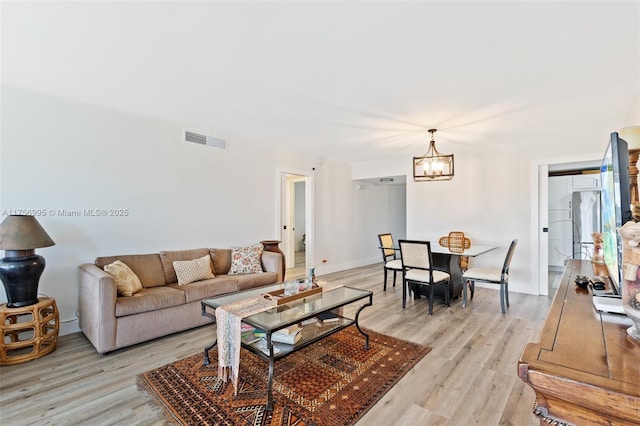 802 Cypress Grove Ln Unit 409, Pompano Beach, FL 33069 - living area with a chandelier and light wood-style flooring