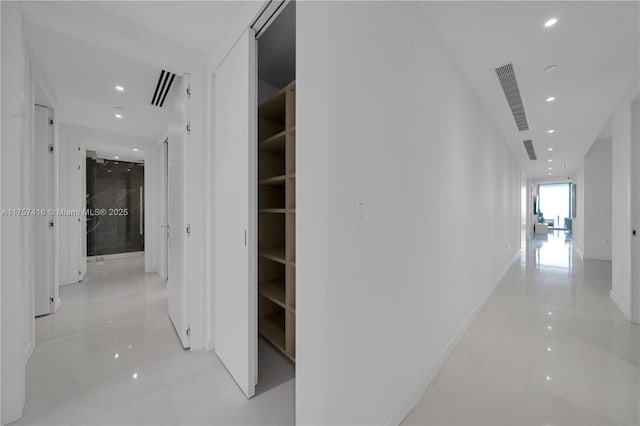 hallway with recessed lighting, visible vents, and baseboards