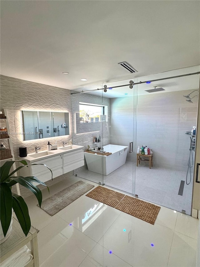 bathroom with a soaking tub, a shower stall, and visible vents