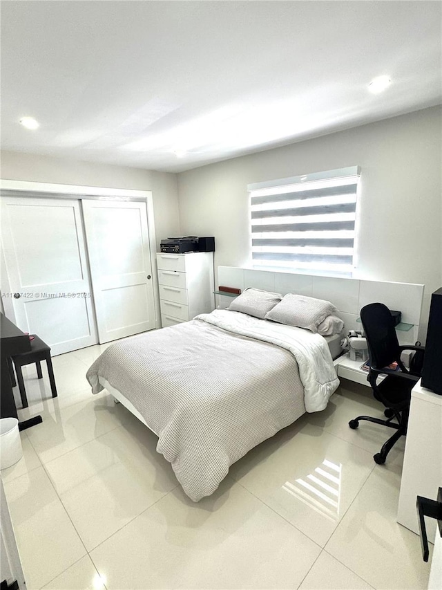 bedroom featuring light tile patterned floors, a closet, and recessed lighting