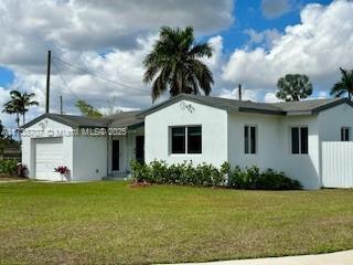 ranch-style house with a garage and a front yard