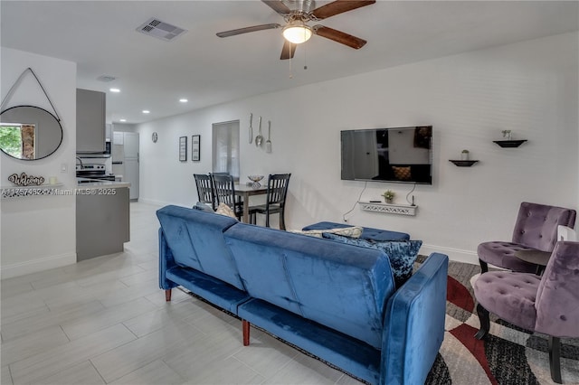 living area featuring baseboards, recessed lighting, visible vents, and a ceiling fan