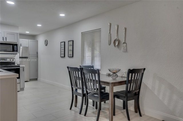 dining space featuring baseboards and recessed lighting