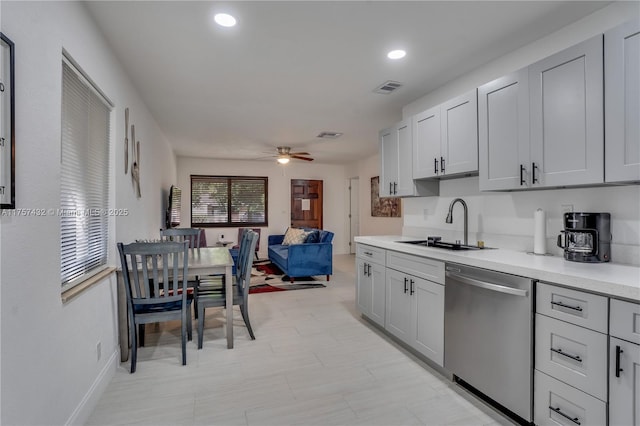 kitchen with dishwasher, ceiling fan, light countertops, a sink, and recessed lighting