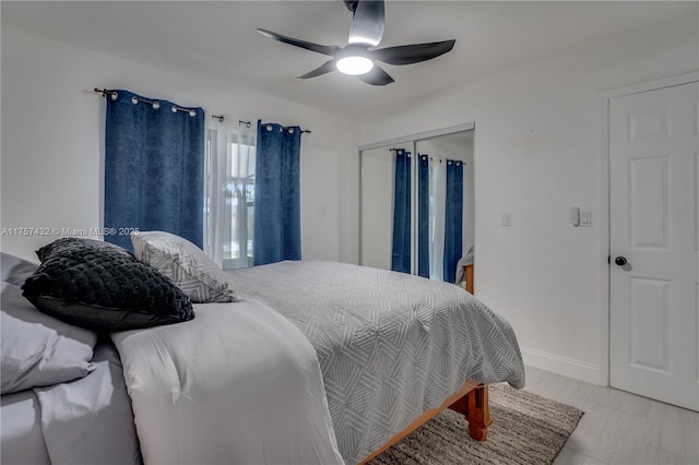 bedroom featuring a ceiling fan, a closet, and baseboards