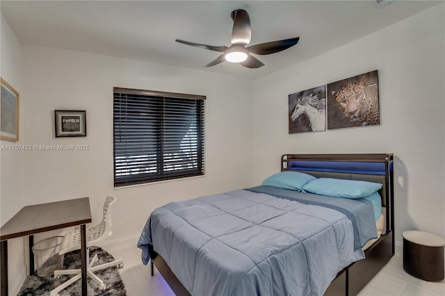 bedroom featuring ceiling fan, wood finished floors, and baseboards