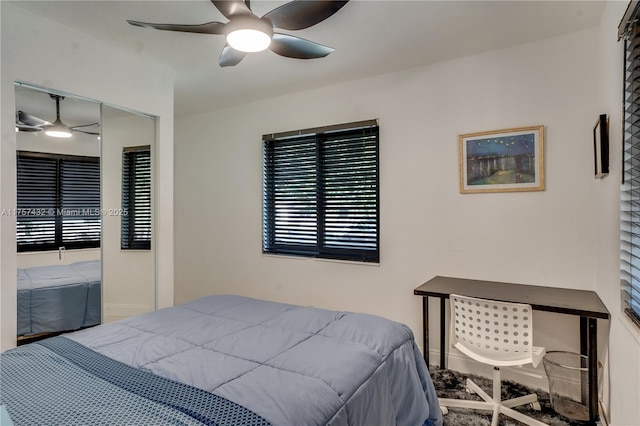 bedroom with ceiling fan and baseboards