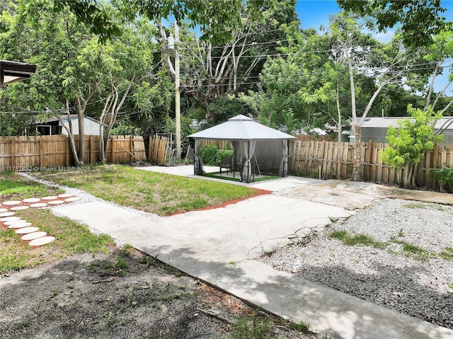 view of yard featuring a patio area, fence, and a gazebo