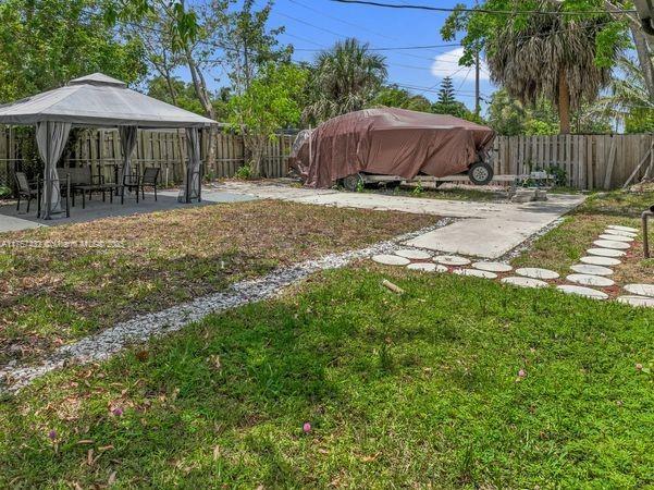 6444 Mcclellan St, Hollywood, FL 33024 - view of yard with a fenced backyard, a gazebo, and a patio
