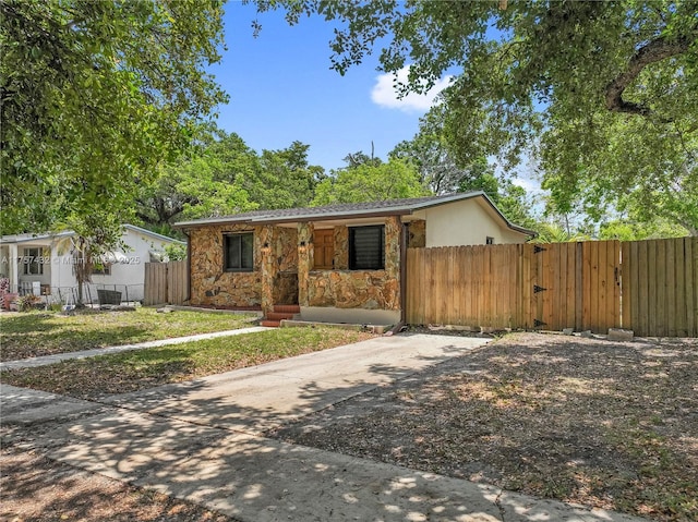 6444 Mcclellan St, Hollywood, FL 33024 - view of front of home with stone siding, fence, and a porch