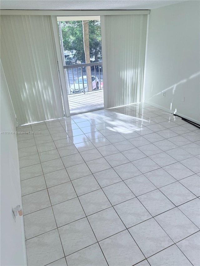 unfurnished room with light tile patterned flooring