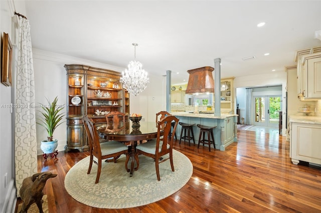 dining room featuring dark wood-style flooring, recessed lighting, and an inviting chandelier