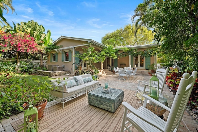 deck with entry steps, an outdoor living space, outdoor dining area, and french doors