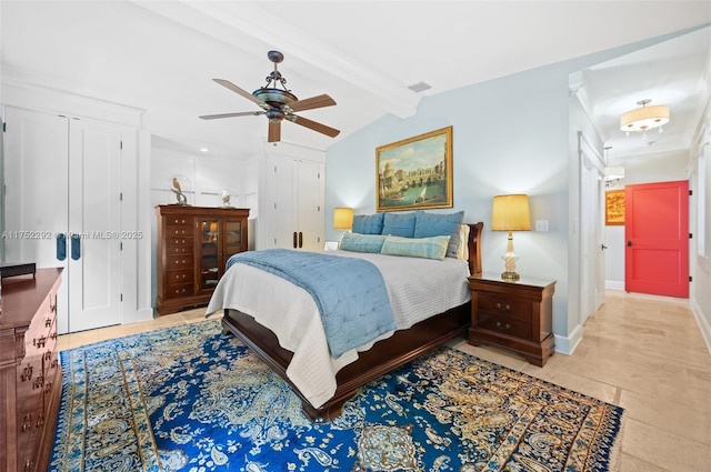 bedroom featuring visible vents, baseboards, vaulted ceiling with beams, ceiling fan, and multiple closets