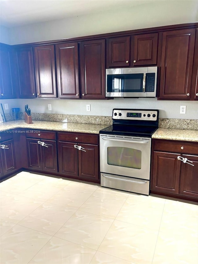 kitchen featuring dark brown cabinets and appliances with stainless steel finishes