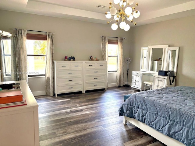 bedroom with dark wood-style floors, multiple windows, and visible vents