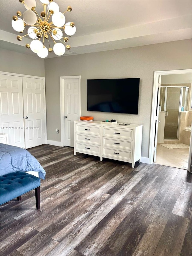 bedroom featuring a notable chandelier, a closet, baseboards, and dark wood-style flooring