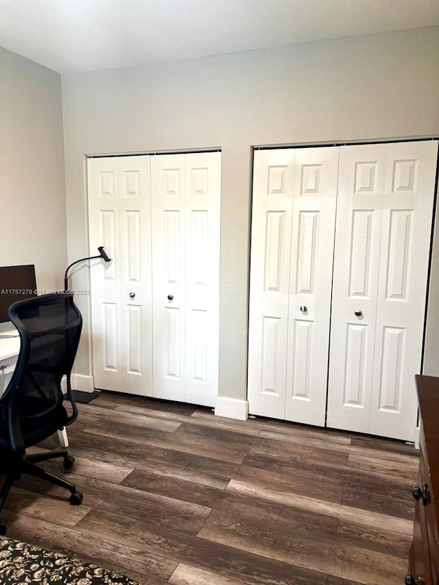 office area with baseboards and dark wood finished floors