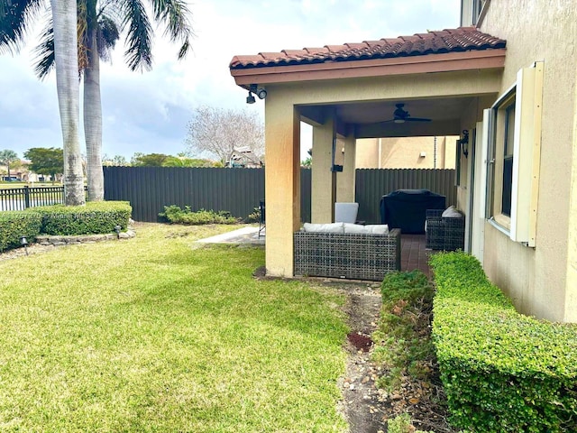 view of yard with ceiling fan, a patio, fence, and an outdoor living space