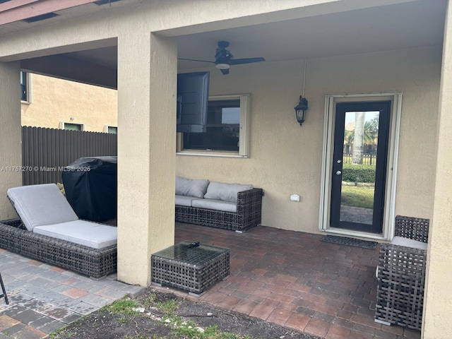 view of patio / terrace with a grill, fence, and a ceiling fan