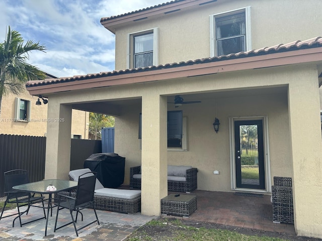 view of patio with outdoor dining area, area for grilling, and fence