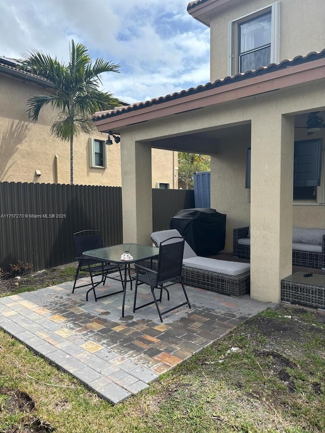 view of patio / terrace with outdoor dining space, fence, and area for grilling