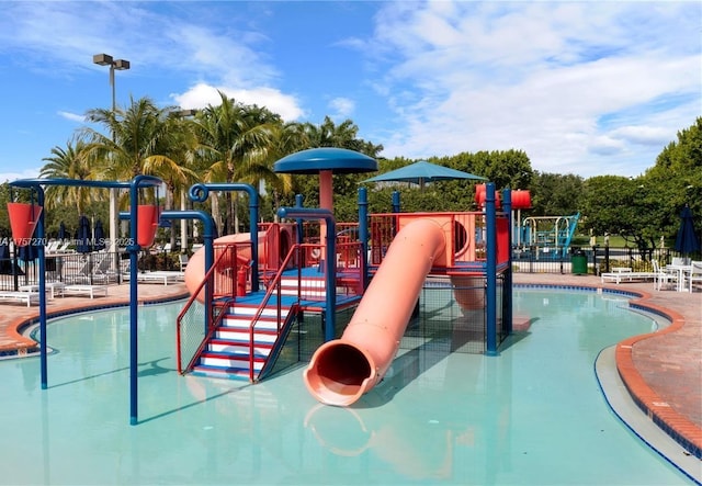 communal playground with a water play area and fence