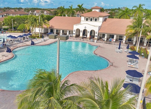 pool featuring a residential view, fence, and a patio