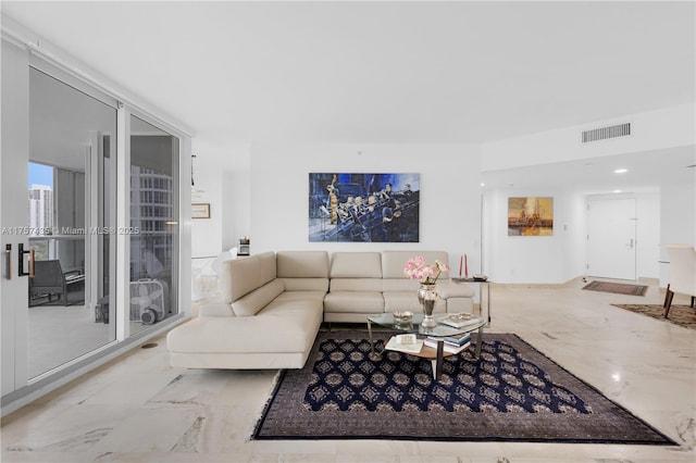 living area featuring marble finish floor and visible vents