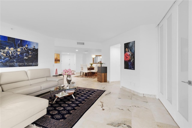 living area featuring marble finish floor, baseboards, and visible vents