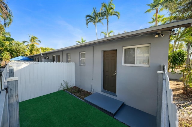 exterior space with fence and stucco siding