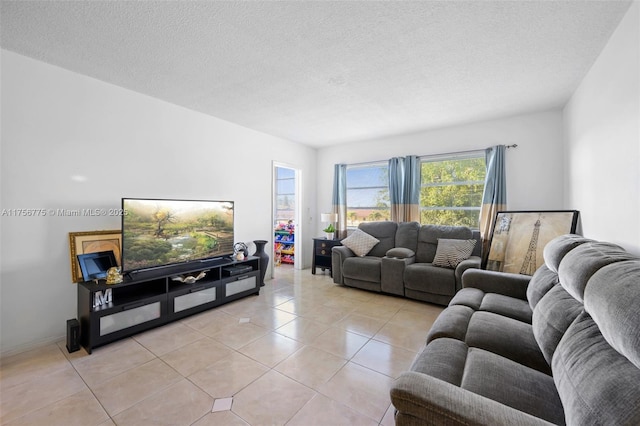 living area featuring light tile patterned floors and a textured ceiling