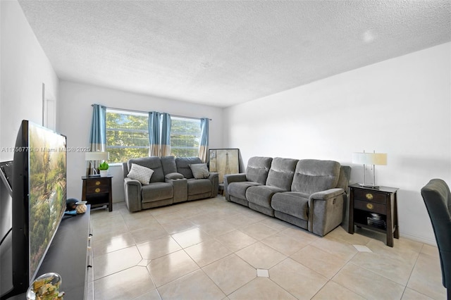 living room with a textured ceiling and light tile patterned flooring