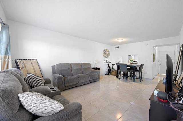 living room with light tile patterned flooring and visible vents