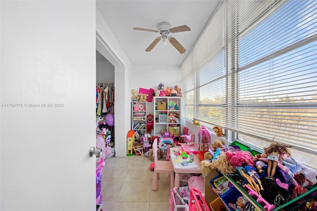 playroom with light tile patterned floors and a ceiling fan