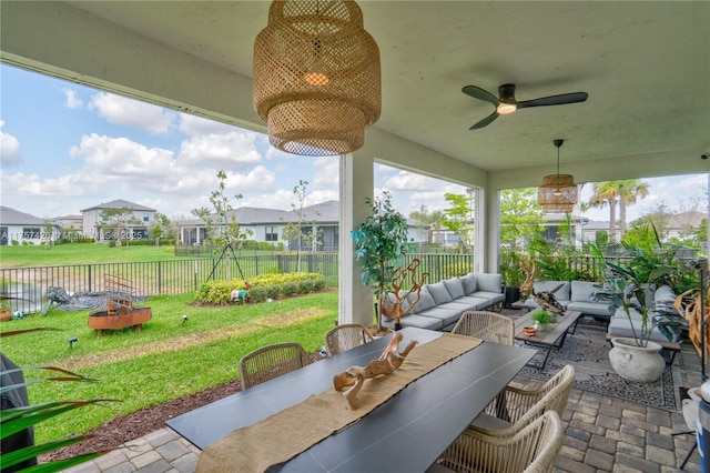 view of patio / terrace with a ceiling fan, a residential view, a fenced backyard, and an outdoor living space