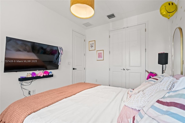 bedroom with visible vents and a closet