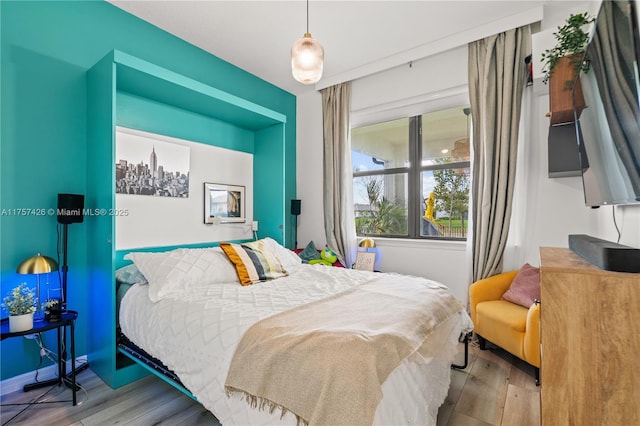 bedroom with wood finished floors