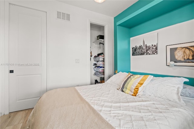 bedroom with visible vents and wood finished floors