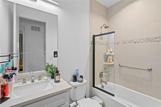 full bathroom featuring toilet, bathing tub / shower combination, vanity, and visible vents