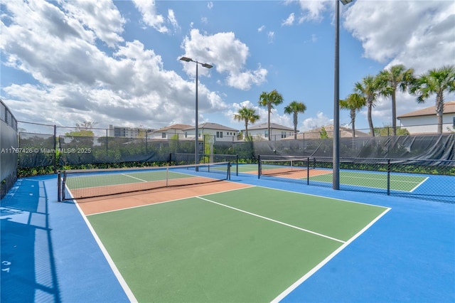 view of sport court featuring fence