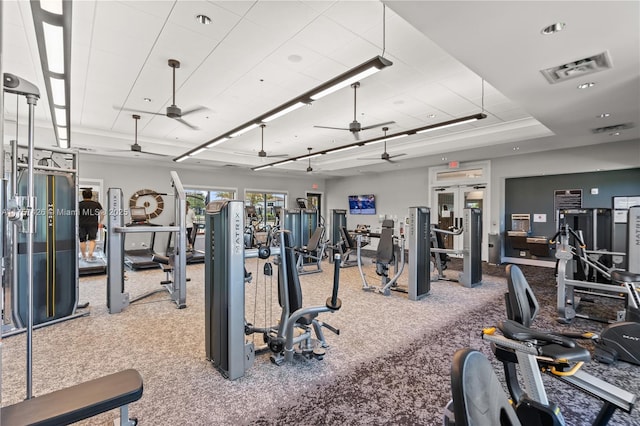 workout area with french doors, carpet flooring, visible vents, and a ceiling fan