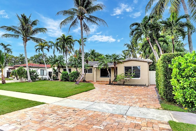 single story home with a front lawn and stucco siding