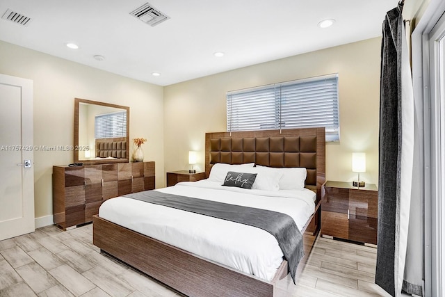 bedroom featuring wood tiled floor, visible vents, and recessed lighting