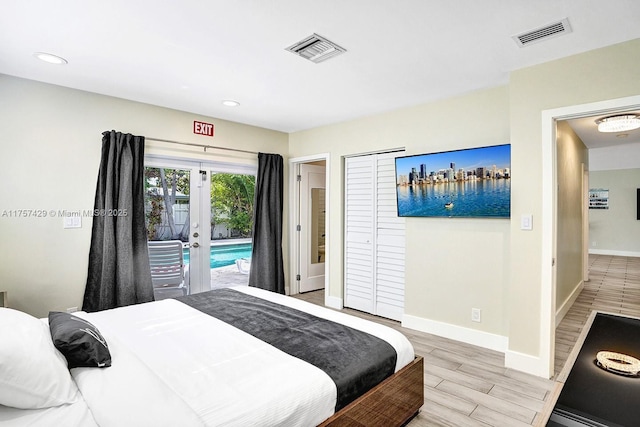 bedroom featuring access to exterior, light wood-style flooring, visible vents, and baseboards