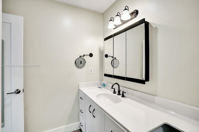 bathroom featuring baseboards and vanity